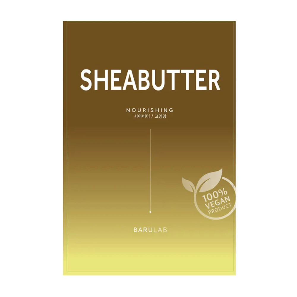En pakke af BARULAB "SHEABUTTER Nourishing" maske, mærket som "100% Vegan Product". Pakken har en farvegradient, der går fra mørk gyldenbrun i toppen til lys gul i bunden.