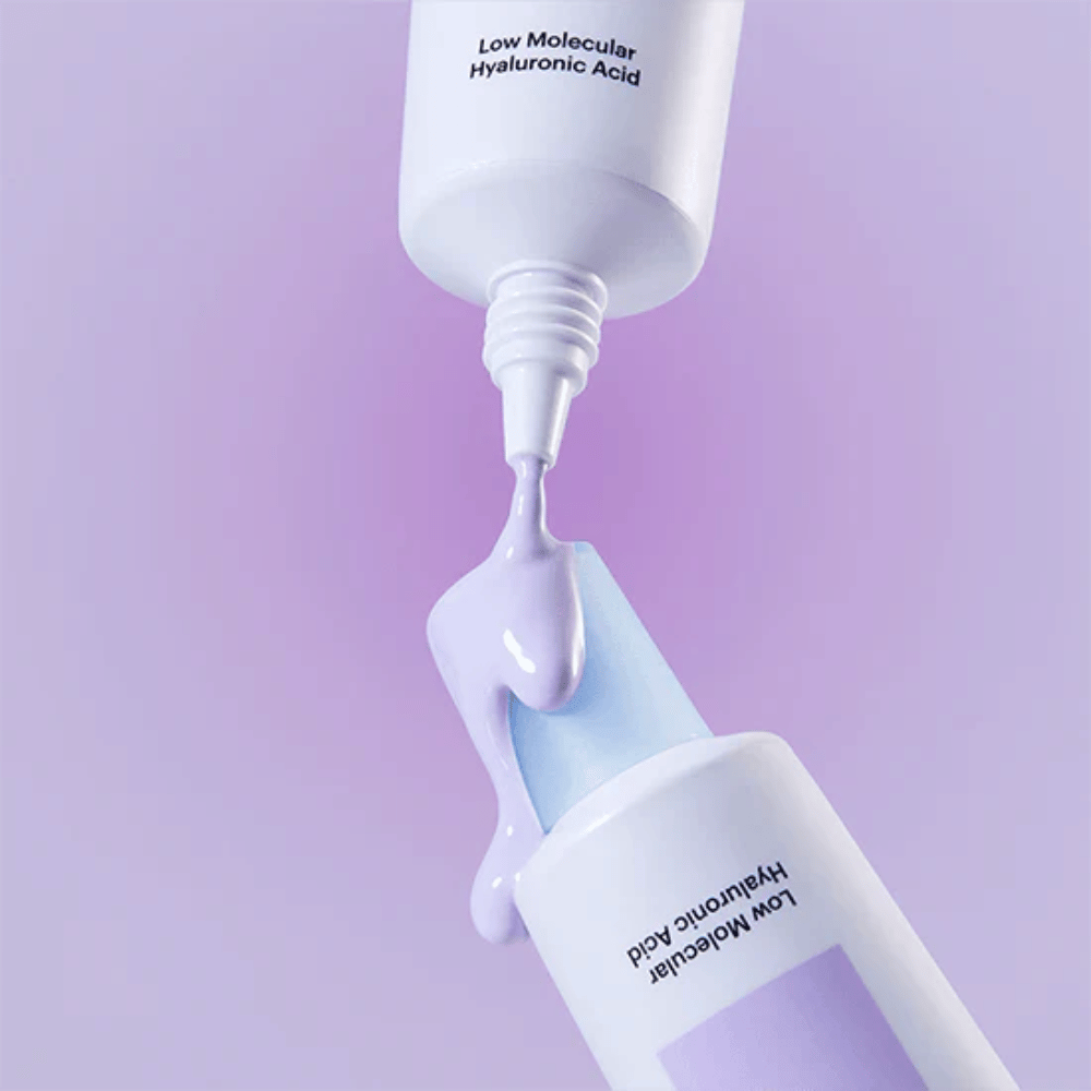 Nærbillede af Torriden DIVE IN Tone Up Sun Cream Purple, hvor den lilla creme påføres fra tuben for at illustrere produktets konsistens.