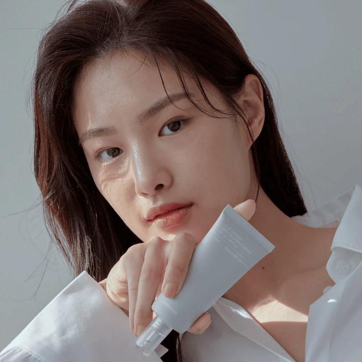 Model der holder Celimax Dual Barrier Skin Wearable Cream, beroligende og barriereforstærkende ansigtscreme til følsom hud og tør hud.