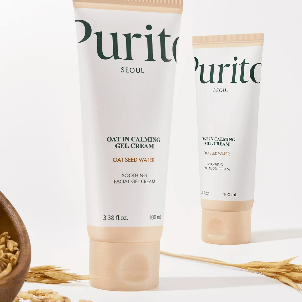 Purito Oat-In Calming Gel Cream i beige tube, placeret med havrekorn. Beroliger følsom hud med havrevatten og let geltekstur.
