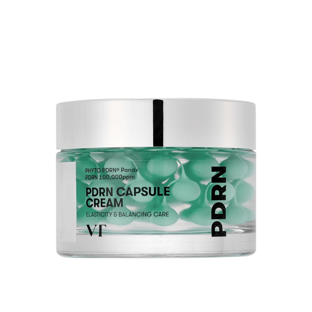 VT PDRN Capsule Cream i en transparent krukke med sølvlåg. Indholdet består af grønne kapsler i en klar gel, og etiketten viser, at cremen er beregnet til elasticitet og balancerende hudpleje.