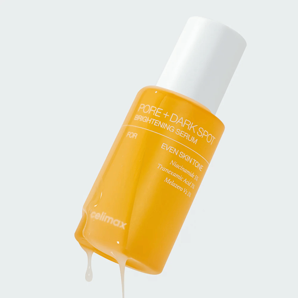 Celimax Pore + Dark Spot Brightening Serum i gul flaske med hvid kork, dråber af serum løber langs flasken.