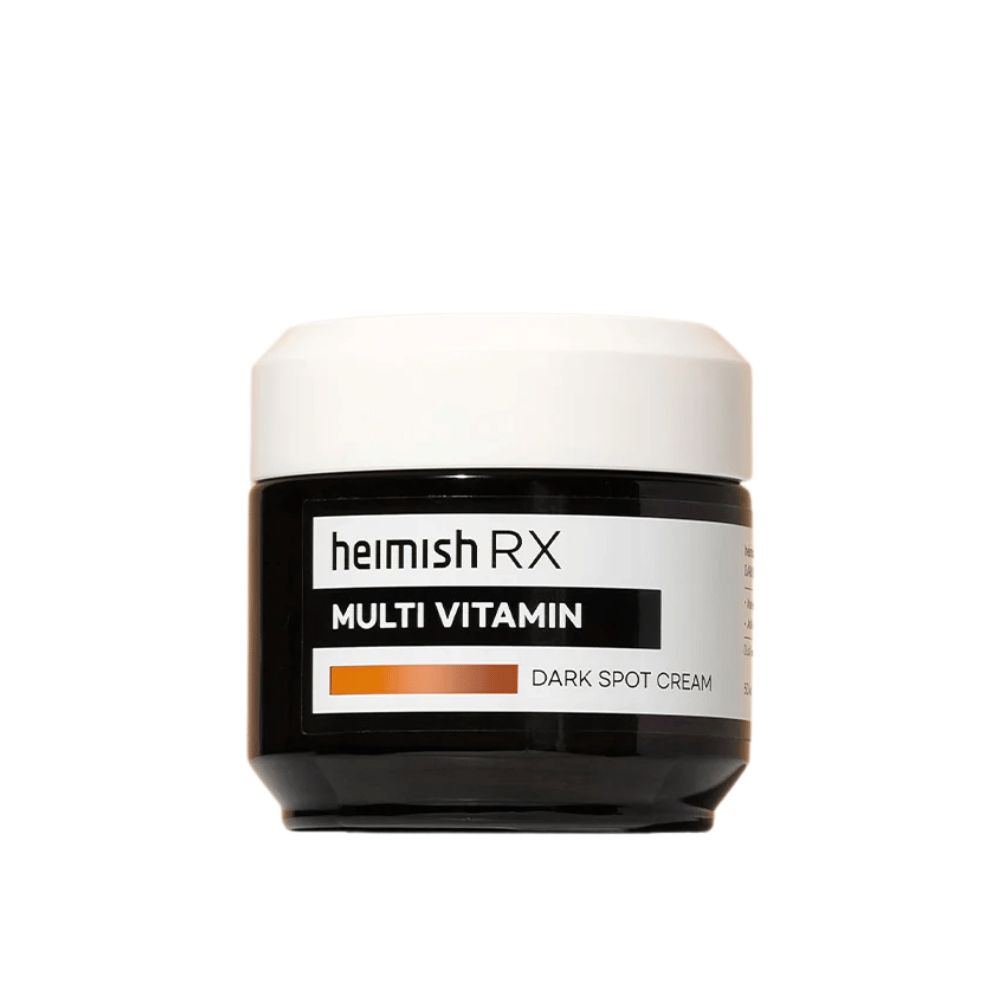 Heimish RX Multi Vitamin Dark Spot Cream i en stilren sort krukke med hvidt låg. En ansigtscreme beriget med multivitaminer, udviklet til at reducere mørke pletter og jævne hudtonen.