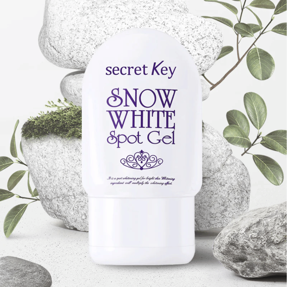 Secret Key Snow White Spot Gel fotograferet mod sten og grønne blade.