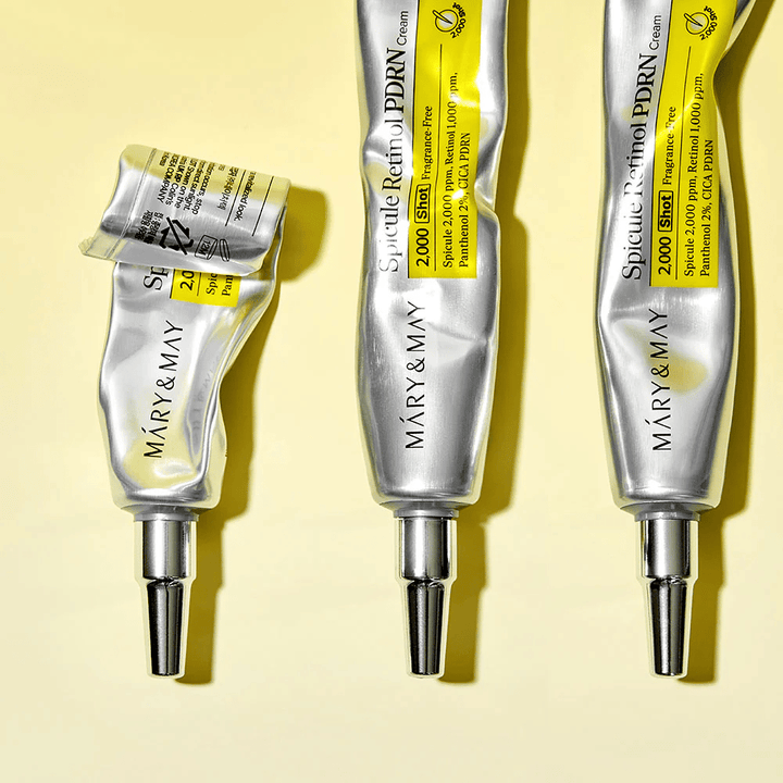 MARY & MAY Spicule Retinol PDRN Cream med synlig brug i tube, viser cremens konsistens og målrettet applikator til præcis påføring på huden.