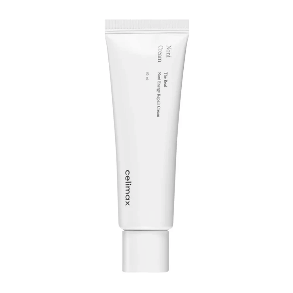 Celimax Noni Energy Repair Cream i en hvid tube med sort tekst. Produktet er mærket som "The Real Noni Energy Repair Cream" og har en volumen på 50 ml.
