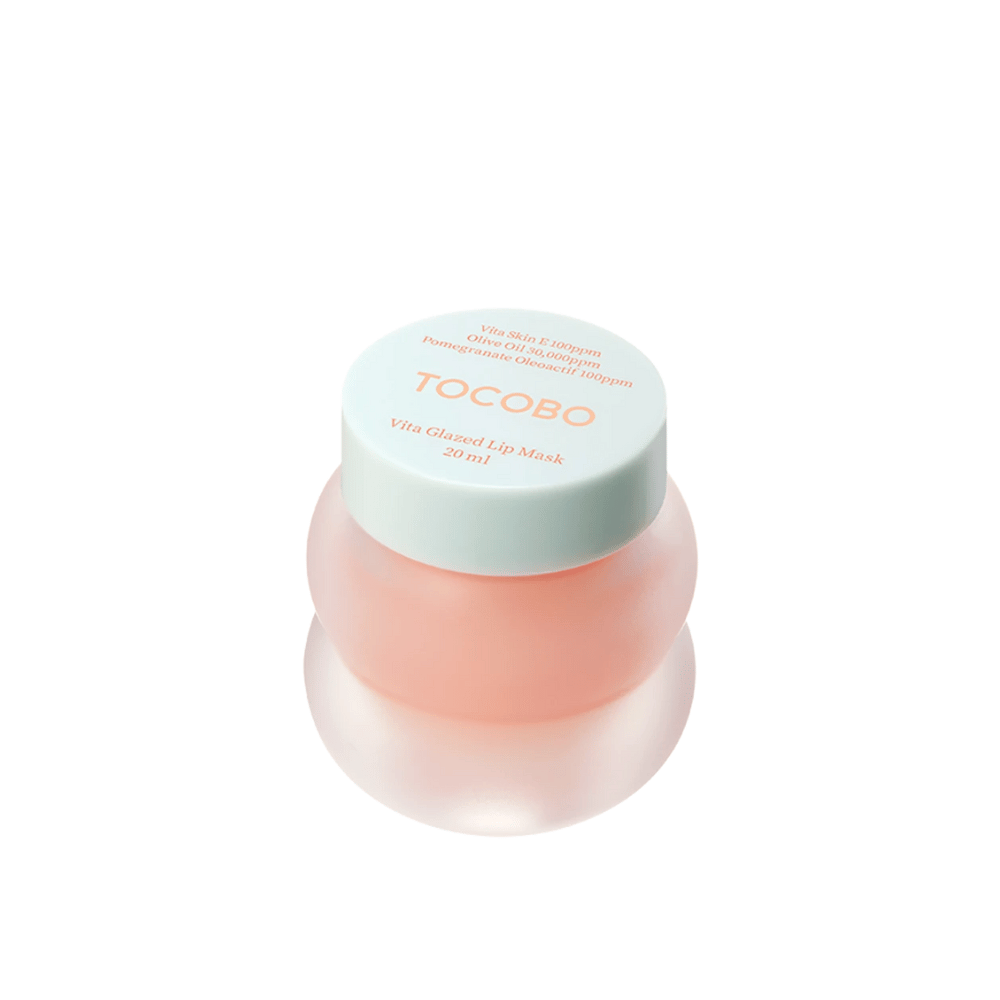 En krukke med "Vita Glazed Lip Mask" fra Tocobo vises. Krukken er rund og gennemsigtig med et lyst turkis låg. Masken indeni er let rosa og designet til at fugte og pleje læberne. Produktet har et volumen på 20 ml.